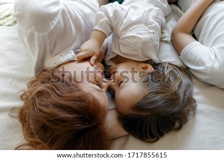 Similar – Little girl playing with boy over the bed