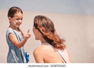 Mother, daughter and nose with sunscreen on beach for summer protection for healthy skin, safety or weekend. Woman, child and happy in Florida for bonding holiday for vacation, sunshine or outdoor - Powered by Shutterstock