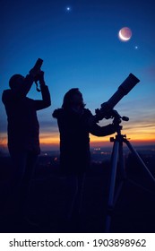 Mother and daughter observing stars, planets, Moon and night sky with astronomical telescope. - Shutterstock ID 1903898962