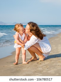 Mother And Daughter On The Beach