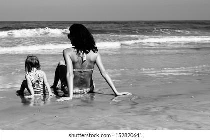 Mother And Daughter On The Beach