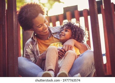 Mother and daughter on playground. - Powered by Shutterstock