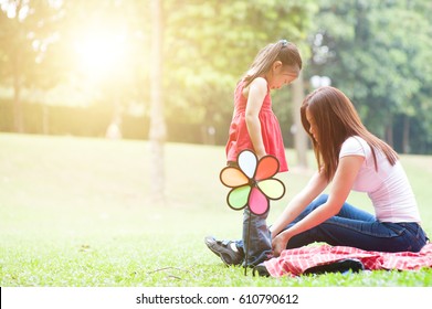 Mother And Daughter In The Park , Asian Family Outdoor Lifestyle, Morning With Sun Flare.