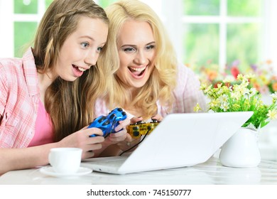 Mother And Daughter Playing Computer Game