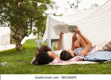 Mother And Daughter Playing In Home Made Garden Den