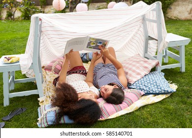 Mother And Daughter Playing In Home Made Garden Den