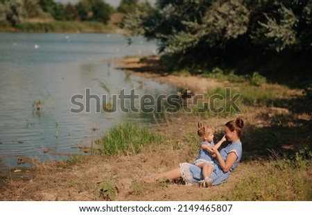 Mother and daughter playing on the lake