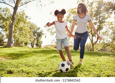 Mother And Daughter Playing Soccer In Park Together - Powered by Shutterstock