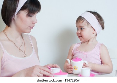 Mother And Daughter Playing Tea Party