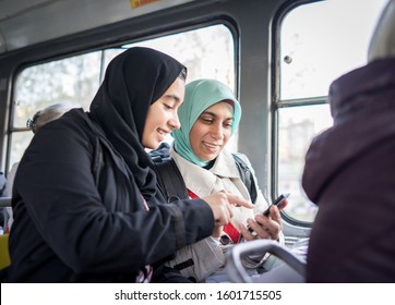 Mother and daughter riding public transport in city - Powered by Shutterstock