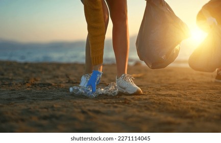 Mother with daughter saving the planet from garbage. - Powered by Shutterstock