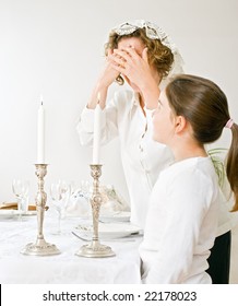 Mother And Daughter With Shabbat Candles