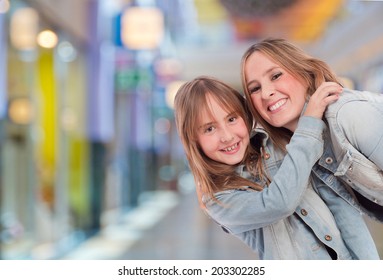 Mother And Daughter In A Shopping Center