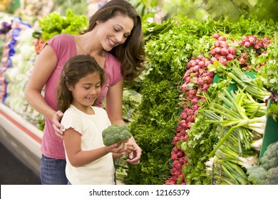 Mother And Daughter Shopping For Fresh Produce In Supermarket