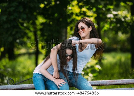 Similar – Happy women embracing and laughing over nature background