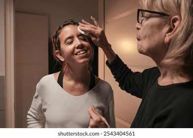 Mother daughter skincare routine in cozy home bathroom setting. Mother's Day. - Powered by Shutterstock