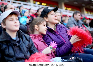 Mother with daughter and son among fans at stadium