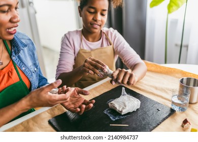 Mother And Daughter Spend Time Together And Sculpting From Clay At Home