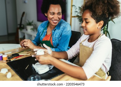 Mother And Daughter Spend Time Together And Sculpting From Clay At Home