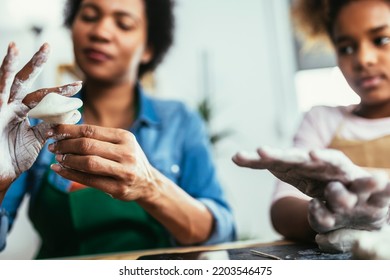 Mother And Daughter Spend Time Together And Sculpting From Clay At Home