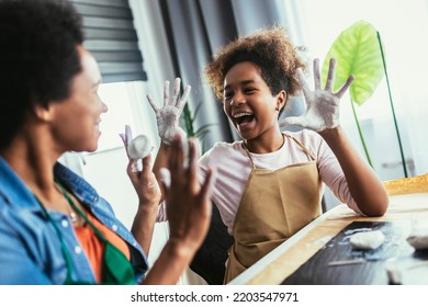 Mother And Daughter Spend Time Together And Sculpting From Clay At Home