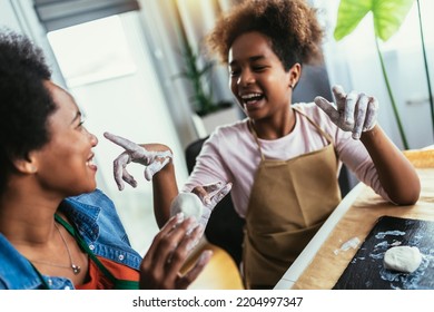 Mother And Daughter Spend Time Together And Sculpting From Clay At Home