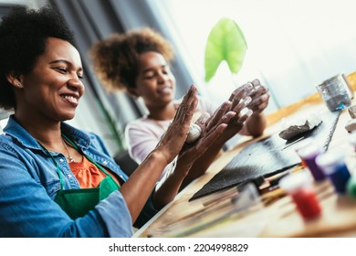 Mother And Daughter Spend Time Together And Sculpting From Clay At Home