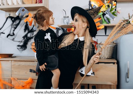 Mother and daughter  standing  in fancy dress. Woman scary and screaming