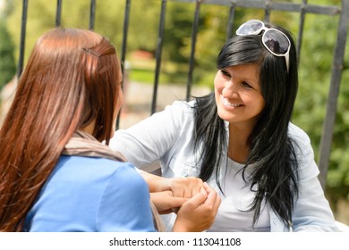 Mother And Daughter Talking Holding Hands Teen Smiling Outdoors Bonding