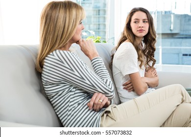 Mother And Daughter Talking On Sofa