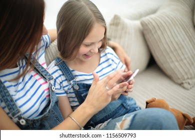 mother and daughter talking, sitting on the couch