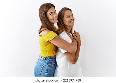 Mother And Daughter Together Standing Together Over Isolated Background Looking To Side, Relax Profile Pose With Natural Face And Confident Smile. 