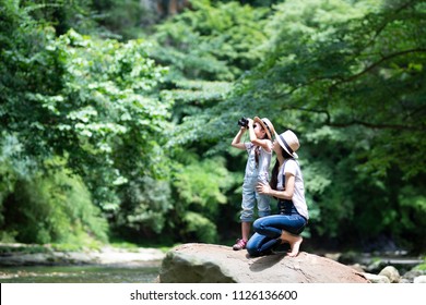 Mother and daughter using binoculars - Powered by Shutterstock