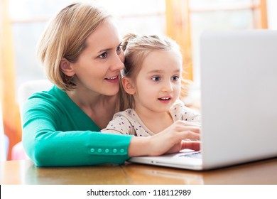 Mother And Daughter Using Laptop