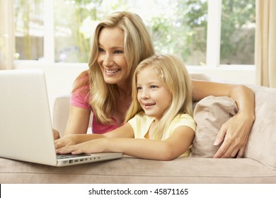 Mother And Daughter Using Laptop At Home