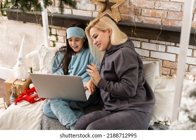 Mother And Daughter Using Laptop Video Call Facetime Chatting Communication To Father With Decorating Christmas Tree In White Room At Home. Smiling Face And Happy To Celebrate New Year Festivel.