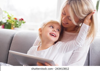 Mother and daughter using tablet computer together