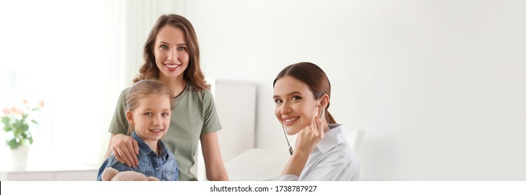 Mother And Daughter Visiting Pediatrician With Stethoscope In Hospital. Banner Design