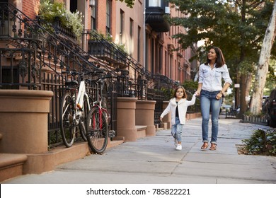 Mother and daughter walking down the street