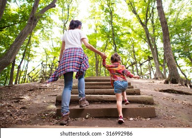 Mother and daughter walking hand in hand