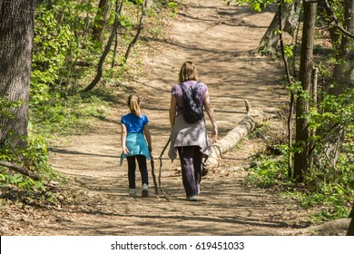 Mother And Daughter Walking In Spring Forest