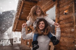 Mother And Daughter In Winter Chalet