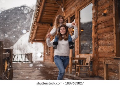 Mother And Daughter In Winter Chalet