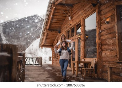 Mother And Daughter In Winter Chalet