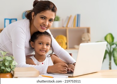 Mother and daughter working on laptop - Powered by Shutterstock