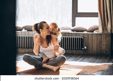 Mother and daughter yoga at home