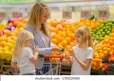 Mother And Daughters Shopping For Healthy Food In Groceries Store