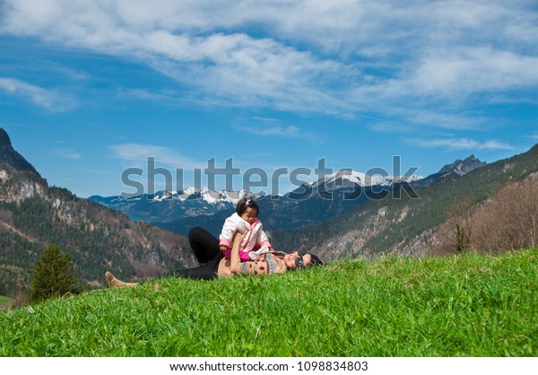 Mother day bonding and Single mom\
concept. Mother is holding and playing baby girl on the mountain in\
sunny day. Family time with mom and daughter in\
summer