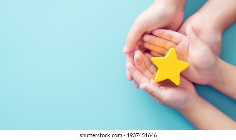 Mother day Concept, Best Excellent mother mom, kid giving a Star Rating to mother.Mother and kid child hand holding star for reward.Family, encourage, School, Student.Child development.Proud, Gifted. - Shutterstock ID 1937451646