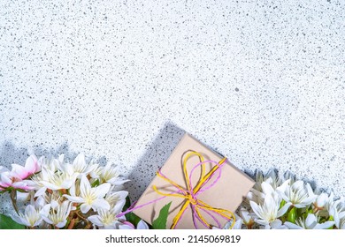 Mother Day Greeting Card Background With Present And Flowers. Gift Box With Festive Ribbon, Tag Love You Mom, Spring Bloom Flowering Branches Bouquet Flatlay Copy Space